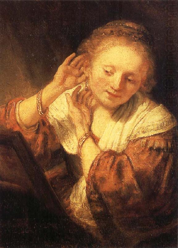 REMBRANDT Harmenszoon van Rijn Young Woman Trying on Earrings china oil painting image